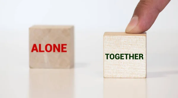 Work together and not alone - two little chalkboards with text on wooden background