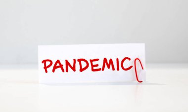 Kart metninde PANDEMIA, sarı tabletler ve termometrenin yanında.