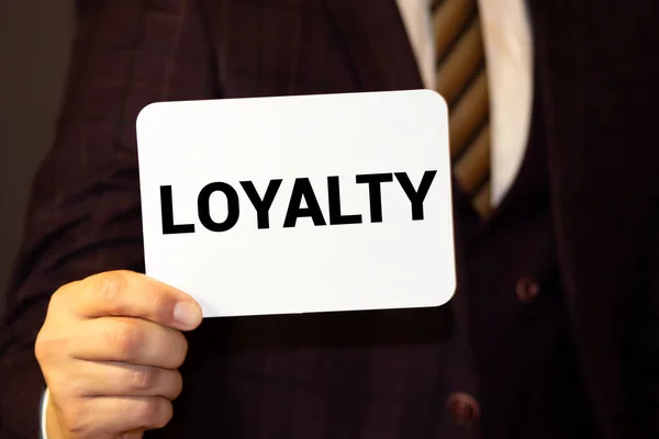 LOYALTY word on the card shown by a man.