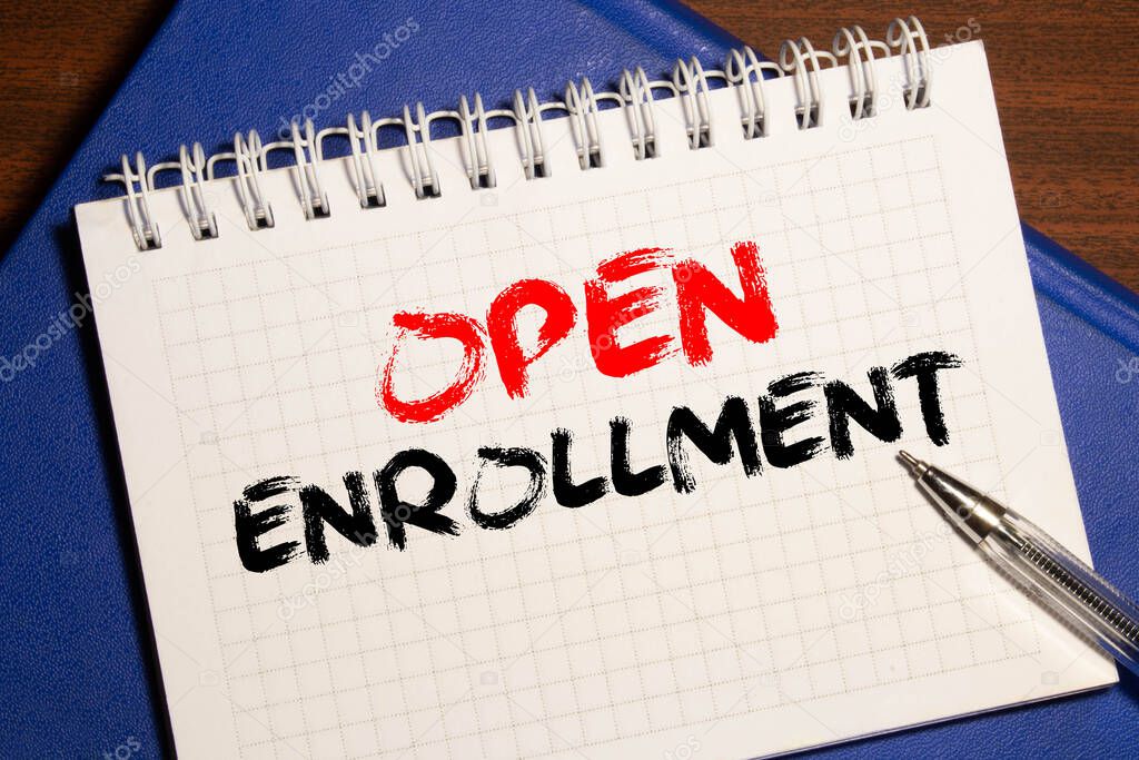 Doctor's desk with notebook and text - Open Enrollment.