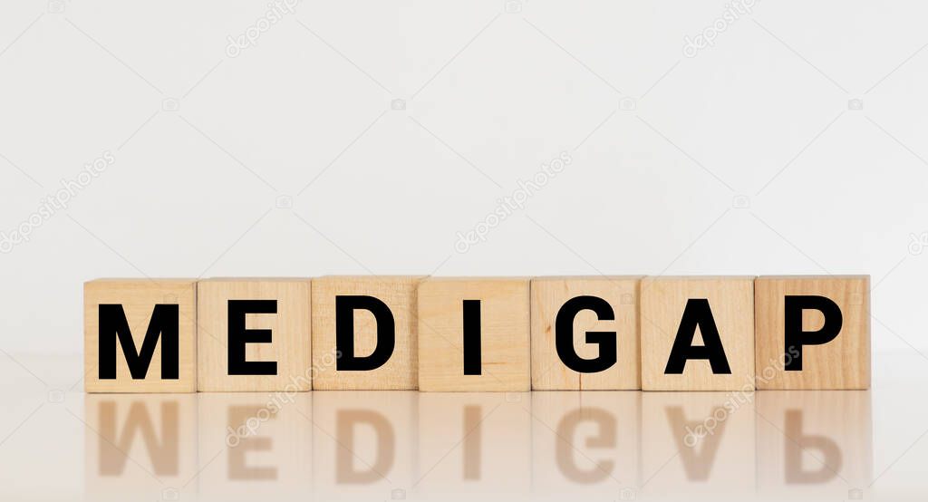 Word Medigap made with wood building blocks.