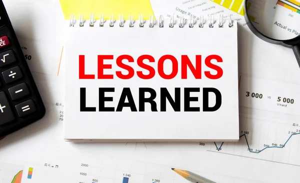 Lessons learned text concept write on notebook.