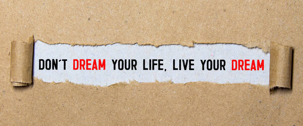 Don't dream your life, live your dream text on red background appears behind torn paper.