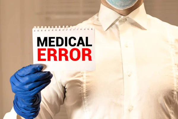 Doctor holding clipboard with medical error text on a sheet of paper on white background