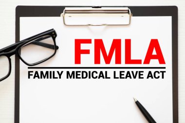 Paper with Family Medical Leave Act FMLA on a table. clipart