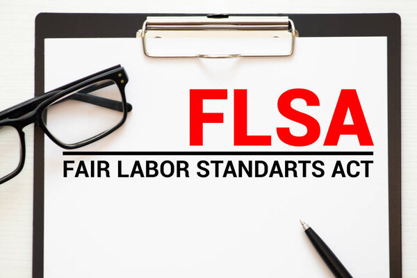 Business photo shows printed text FLSA Fair Labor Standards Act