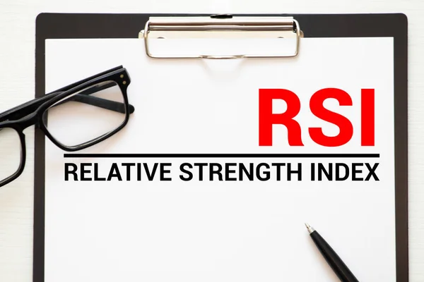 Words Relative Strength Index - RSI written on a book. Business concept