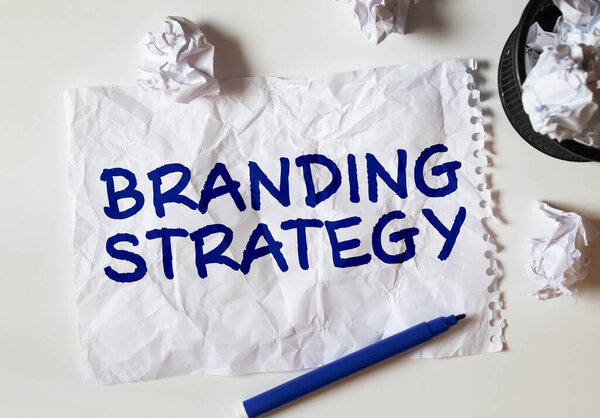 Business concept - Top view notebook writing Branding Strategy.