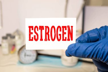 Estrogen Blackboard with word estrogen and stethoscope. Medicine concept clipart