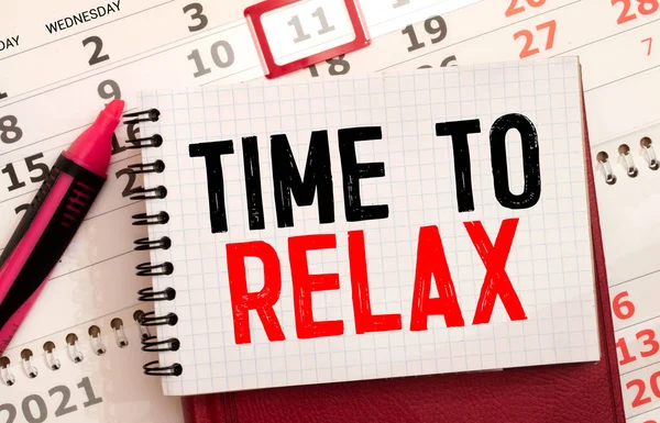 TIME TO RELAX text in notebook on gray background next to pencils and paper clips. Concept