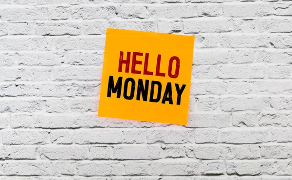 text Hello Monday on yellow short note paper white background.