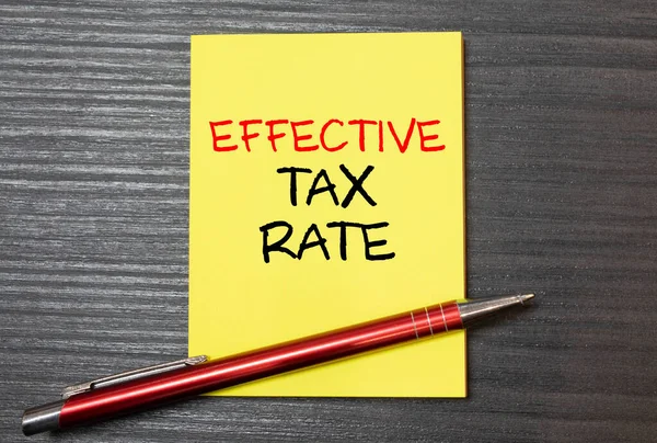 Effective Tax Rate write on a paperwork isolated on wooden background