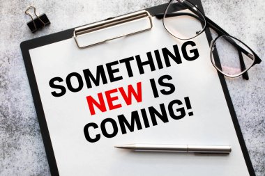 Something new is coming. Business concept. text on white notepad paper clipart