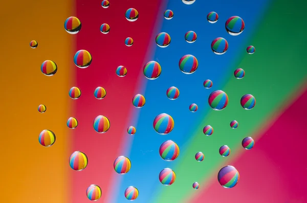 Multicolored drops of water on color  background — Stock Photo, Image