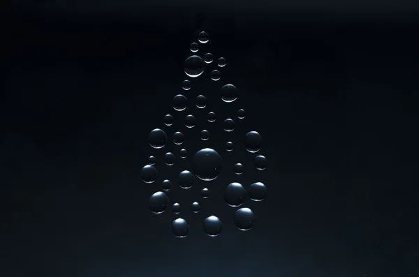 Water drop symbol on  black background — Stock Photo, Image