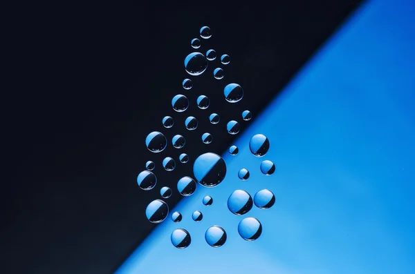 Water drop symbol on blue and black background — Stock Photo, Image