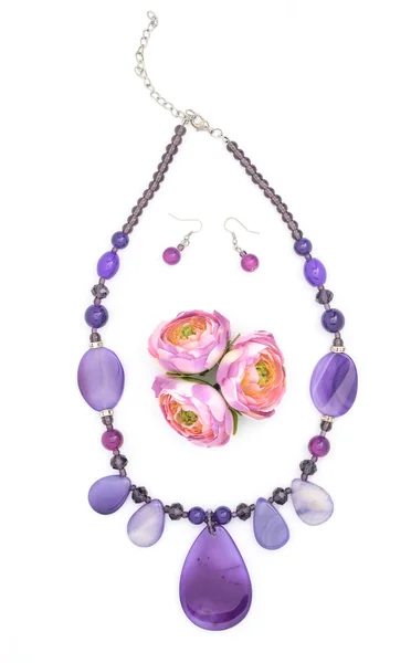 Necklaces, earrings and flowers isolated — Stock Photo, Image