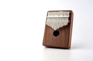traditional, rectangular kalimba on a white background