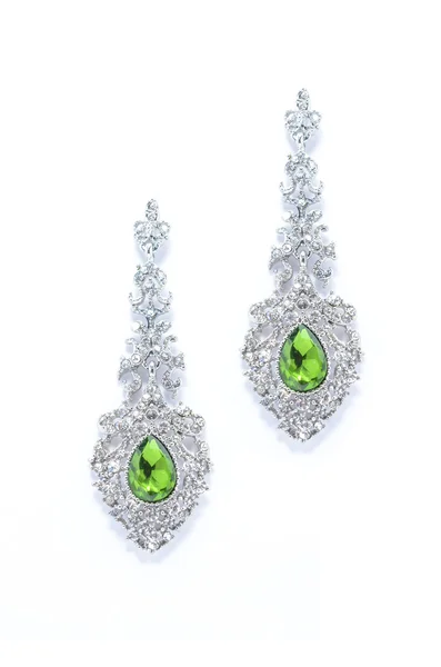 Earrings with emerald  on a white background — Stock Photo, Image