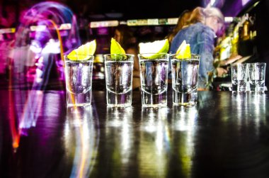 four glasses with Lim on the bar at a nightclub clipart