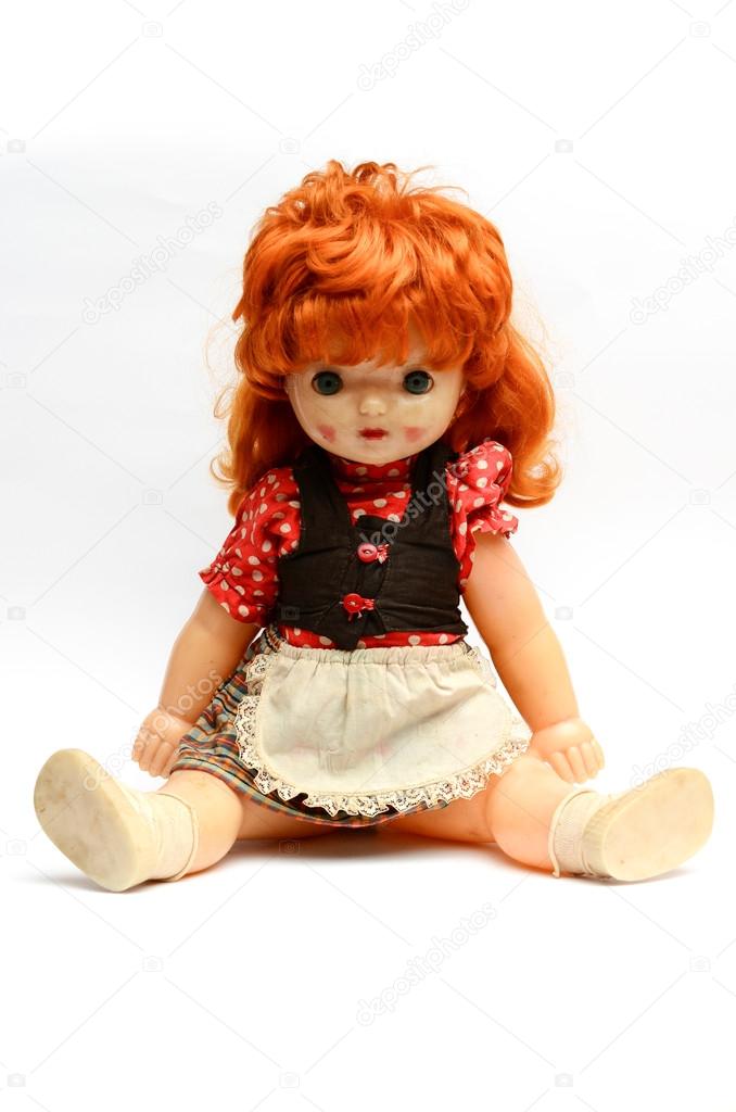 old plastic doll with red hair