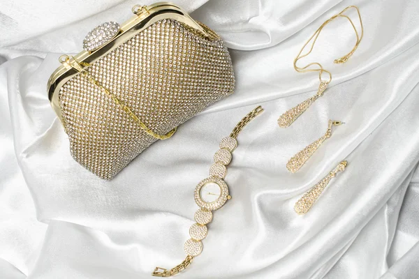 Set of womens accessories on a white silk background — Stock Photo, Image