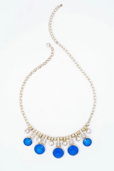 Collar de oro con piedras azules aisladas en blanco — Foto de Stock