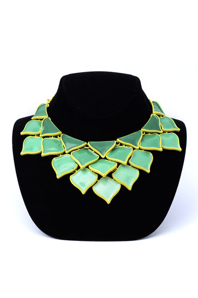 ожерелье с зелеными лепестками на манекене, изолированном на белом
