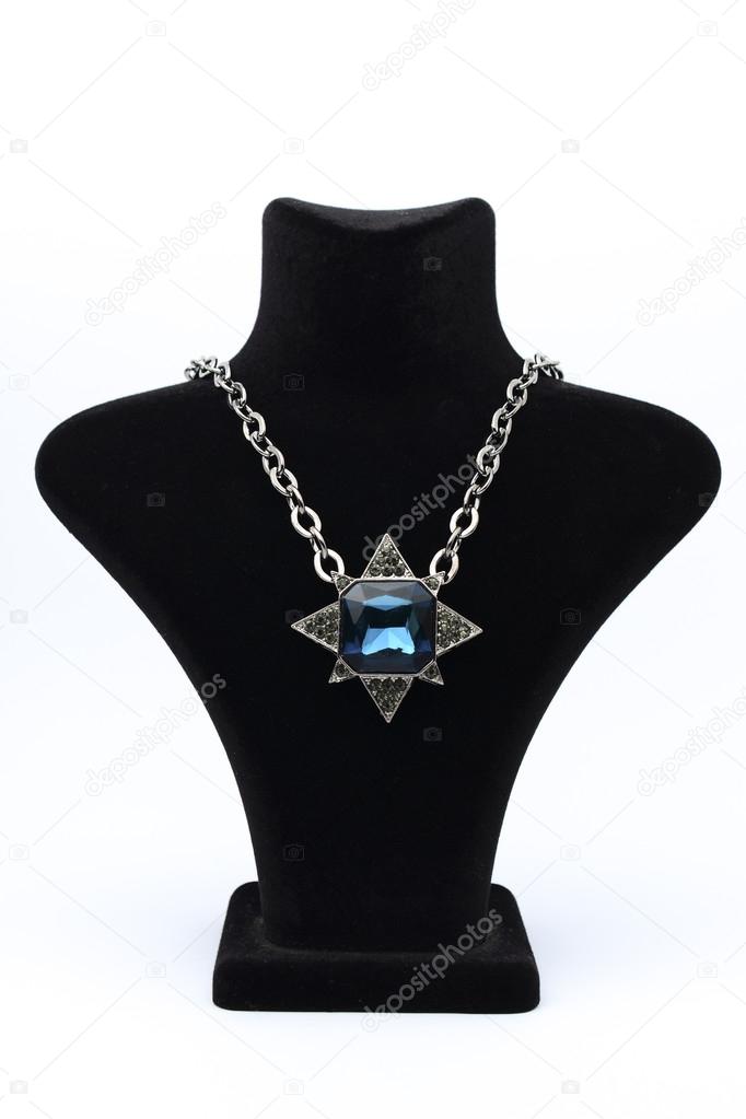 Pendant star  with blue stones on mannequin isolated on white