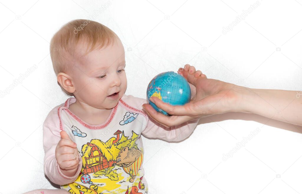 Little child examines the globe