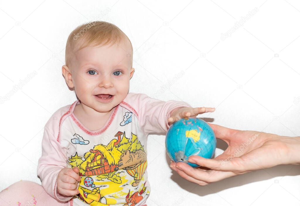 Little child examines the globe