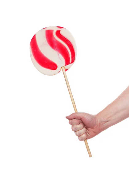 Hand met candy cane lolly — Stockfoto
