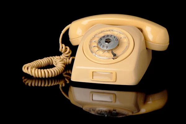 Yellow telephone on black — Stock Photo, Image