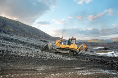Buldozerler dağlık bir ormandaki toprağı kestiler. Madencilik