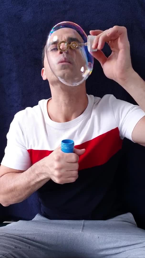 44 años de edad, hombre maduro haciendo una cadena de grandes burbujas de jabón. — Vídeos de Stock