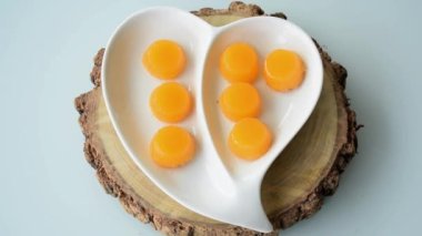 Quindins on a heart-shaped plate. Zoom in. Traditional Brazilian sweet.