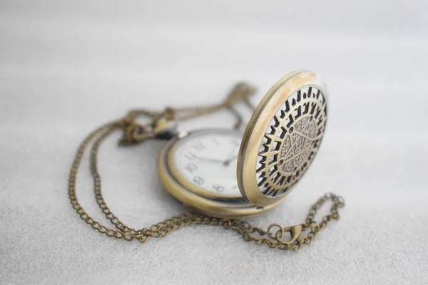 Vintage pocket watch display with chain attached