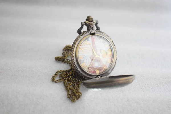 Vintage pocket watch display with chain attached