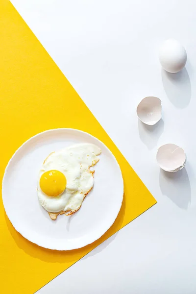 Uovo Fritto Piatto Bianco Fondo Giallo Bianco Composizione Creativa Minima — Foto Stock