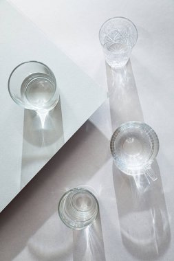 Değişik gözlüklerle en az hareketsiz yaşam. Gri bir masada ilginç gölgeleri olan modern kompozisyon..