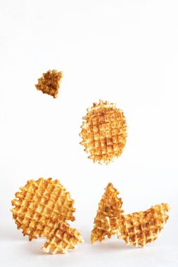 Belgian traditional waffles, creative composition on a light background. Levitating waffles. Minimalism style, selective focus, copy space.