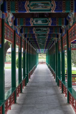 Covered walkway in old traditional park in Beijing,  China clipart