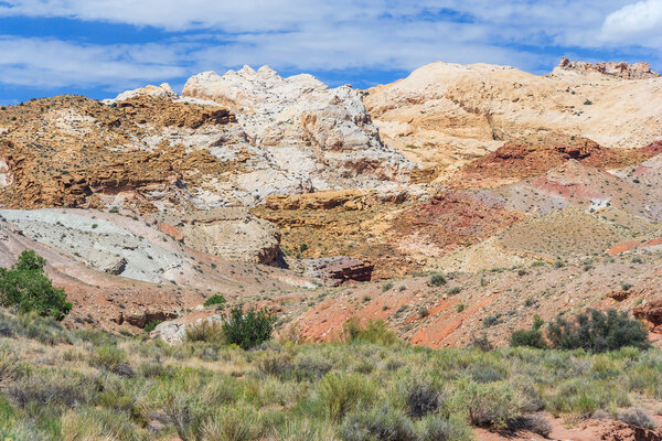 Красочные окрашенные скалы с многослойными осадочными породами в центральной Юте недалеко от Каньонленда, Зайона, Брайса и долины Гоблина
