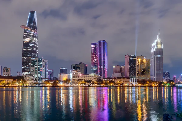 HO CHI MINH CITY, SAIGON / VIETNAM - CIRCA AUGUST 2015: Lights of Saigon downtown skyline are reflected in the river — стоковое фото