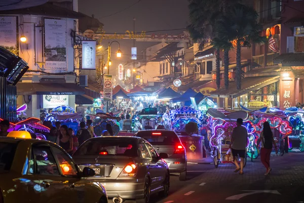 Malacca, Malaysia - circa September 2015: Street traffic, people and market in Malacca, Malaysia by  night