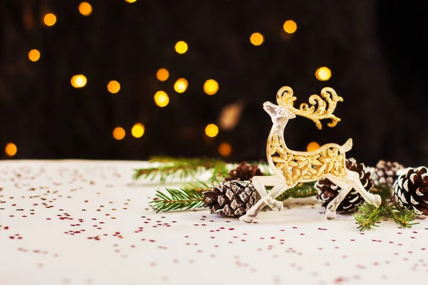 Weihnachtliche Neujahrskomposition Goldene Hirsche Und Tannenzapfen Liegen Auf Weißem Hintergrund — Stockfoto