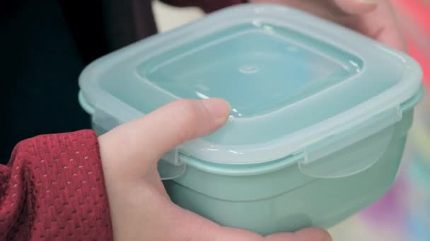 Buying a plastic container for food storage. Close-up shot — Stock Video