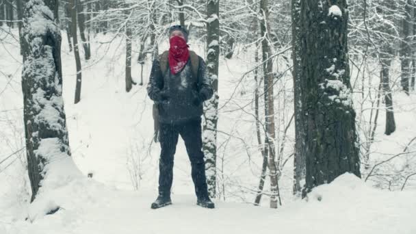 Turista sobe montanha coberta de neve e bebidas de garrafa térmica — Vídeo de Stock