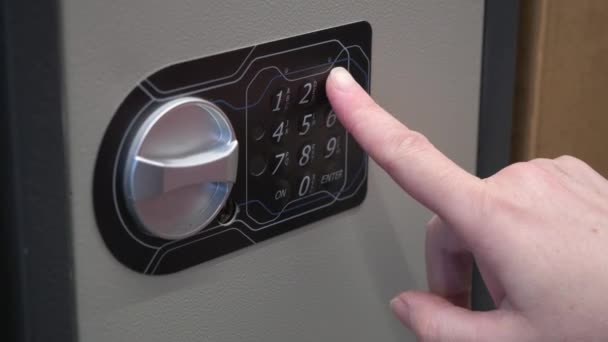 Woman dials a code on an iron safe and opens it. Close up shot — Stock Video