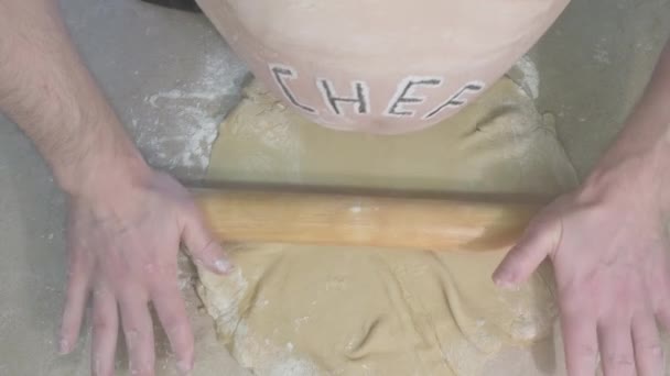 Fat man with word chef on his stomach, rolls out dough and scratches his stomach — Stock Video